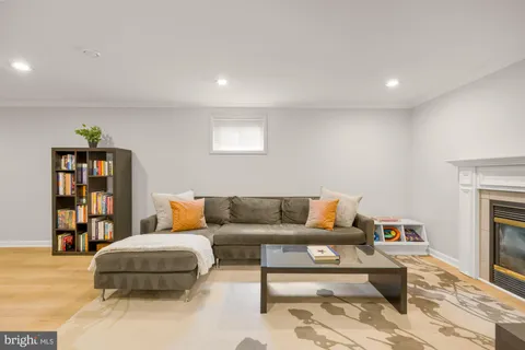 a living room with furniture a rug and a fireplace
