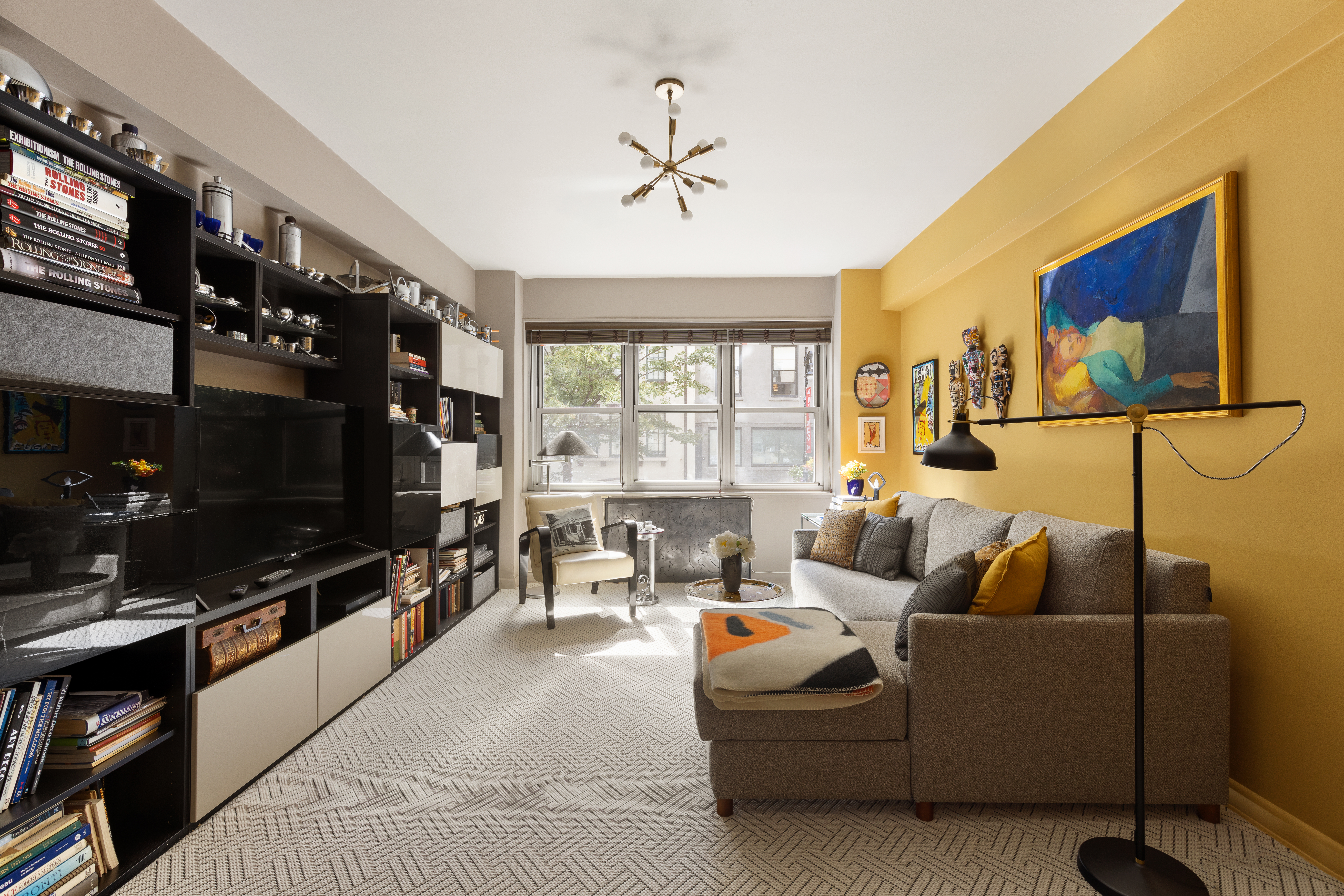 11 5th Avenue, Unit 2D Manhattan, NY 10003 - Photo 9 of 11 a living room with furniture and a flat screen tv