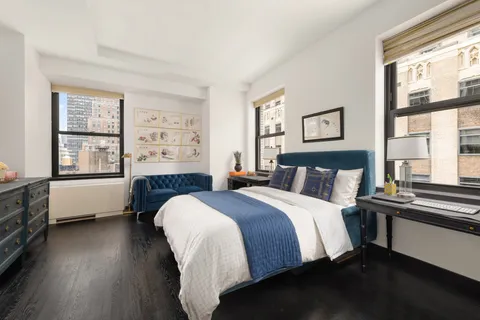 a bedroom with a bed and a large window