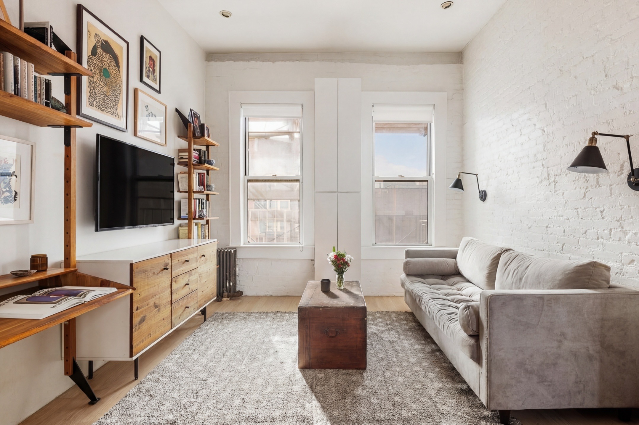 633 East 11th Street, Unit 22 Manhattan, NY 10009 - Photo 2 of 10 a living room with furniture and a flat screen tv