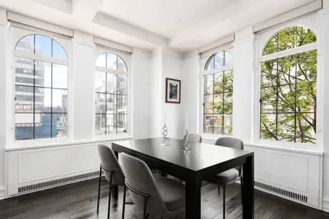 a view of a dining room with a table and chairs