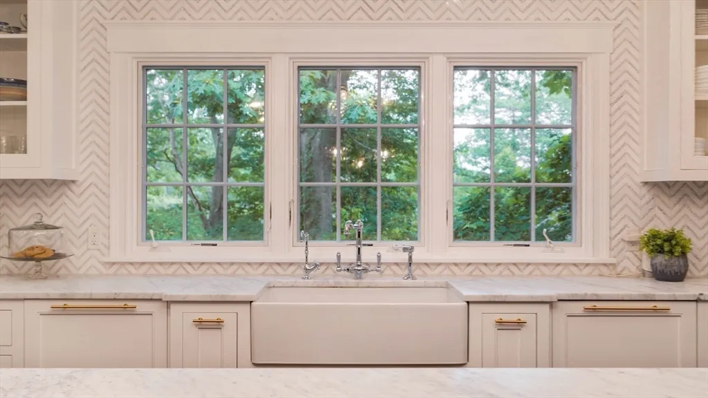a white kitchen sink and window