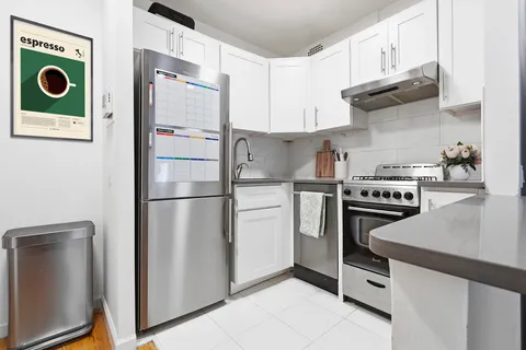 a kitchen with stainless steel appliances granite countertop a refrigerator and a stove