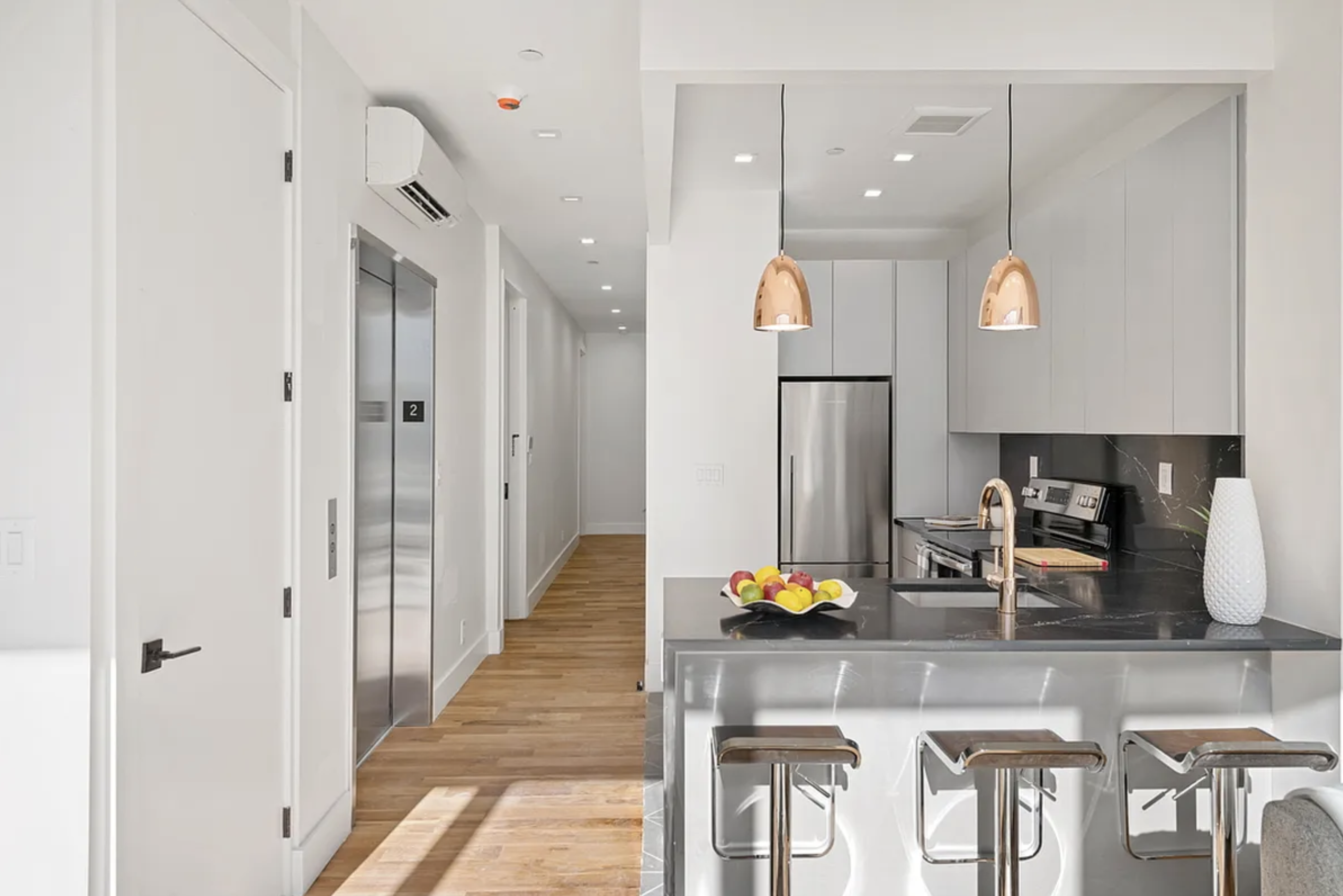 a kitchen with refrigerator and chairs