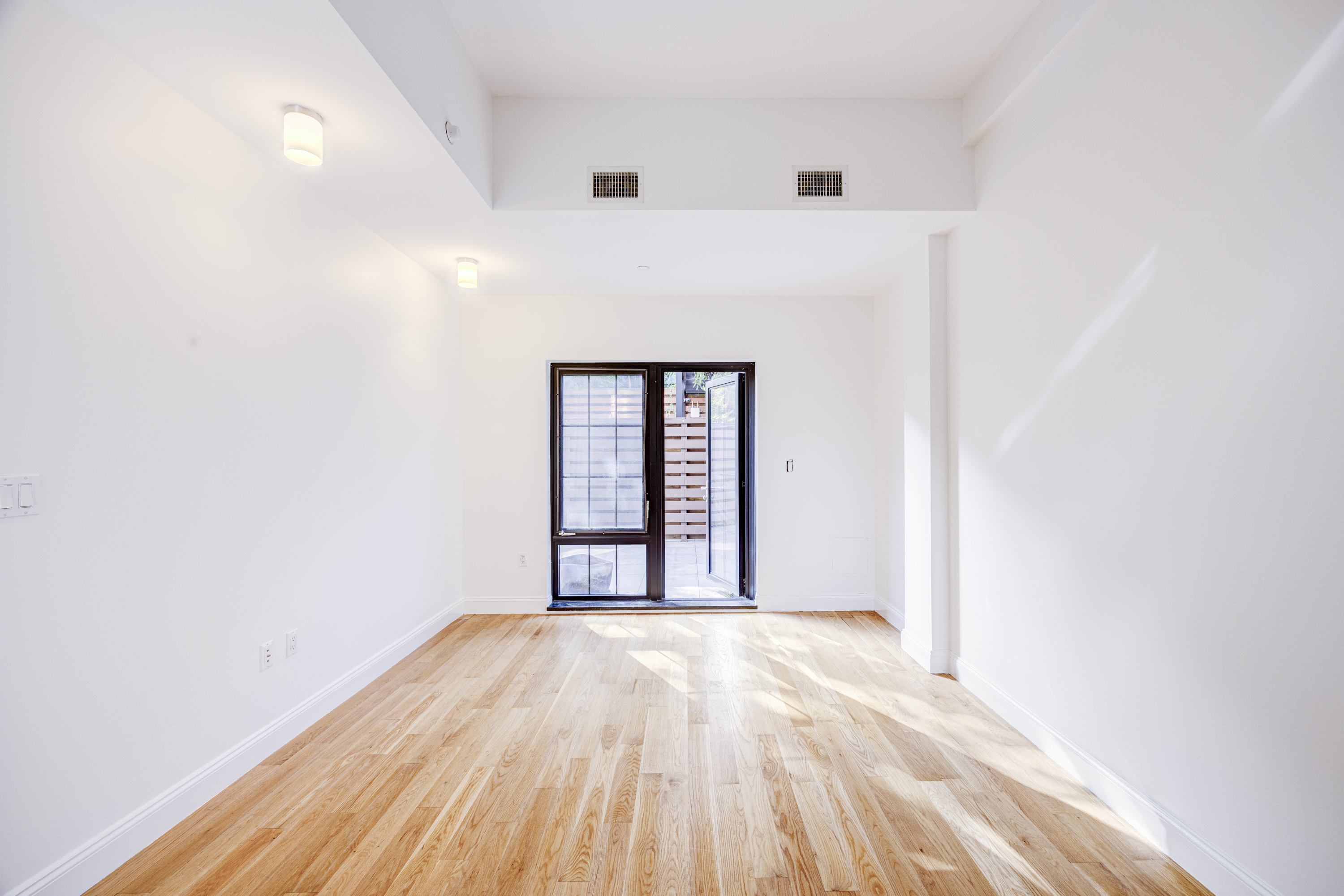 42 Maspeth Avenue, Unit 1D Brooklyn, NY 11211 - Photo 16 of 28 a view of a room with wooden floor and window