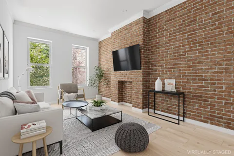 a living room with furniture a flat screen tv and a fireplace