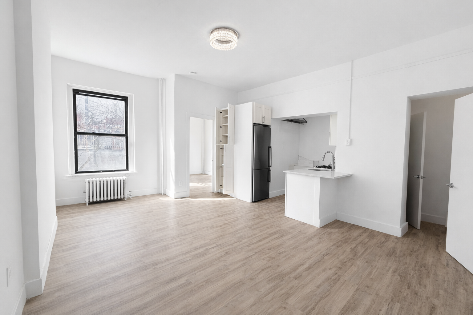 a view of empty room with wooden floor and windows