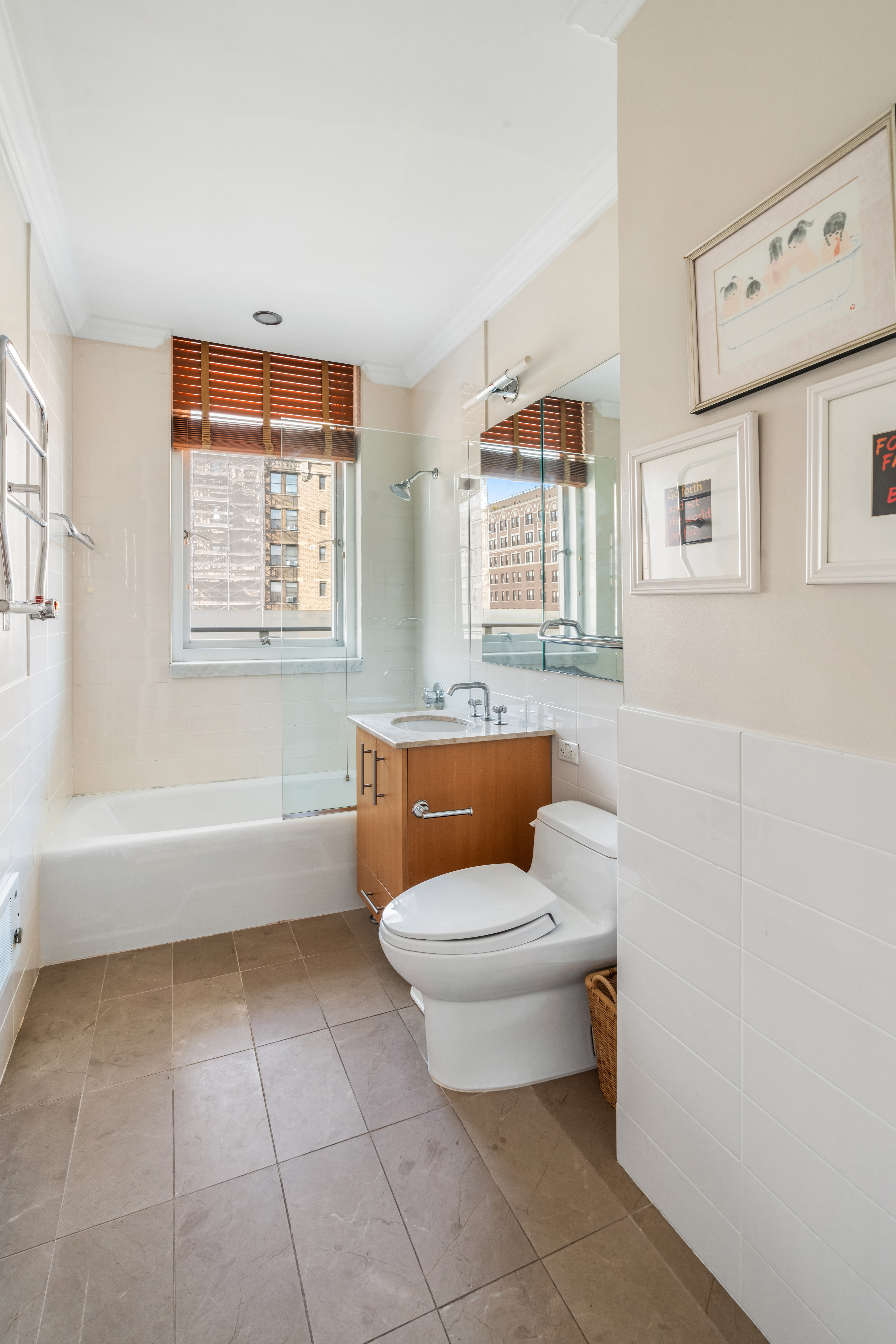 545 West 110th Street, Unit 9D Manhattan, NY 10025 - Photo 10 of 17 a bathroom with a toilet a sink and bathtub