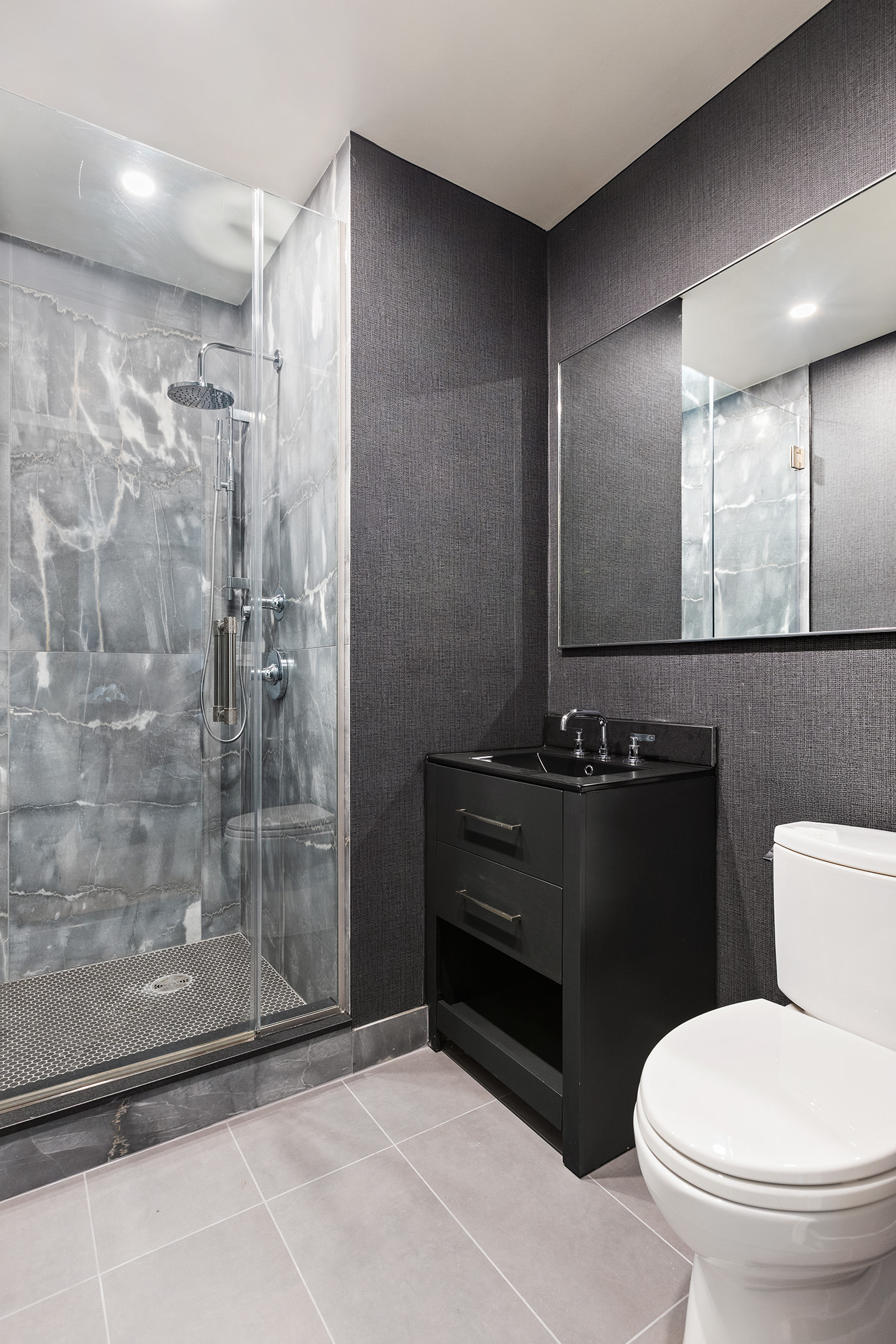 450 West 17th Street, Unit 1709 Manhattan, NY 10011 - Photo 14 of 27 a bathroom with a toilet a sink and a shower