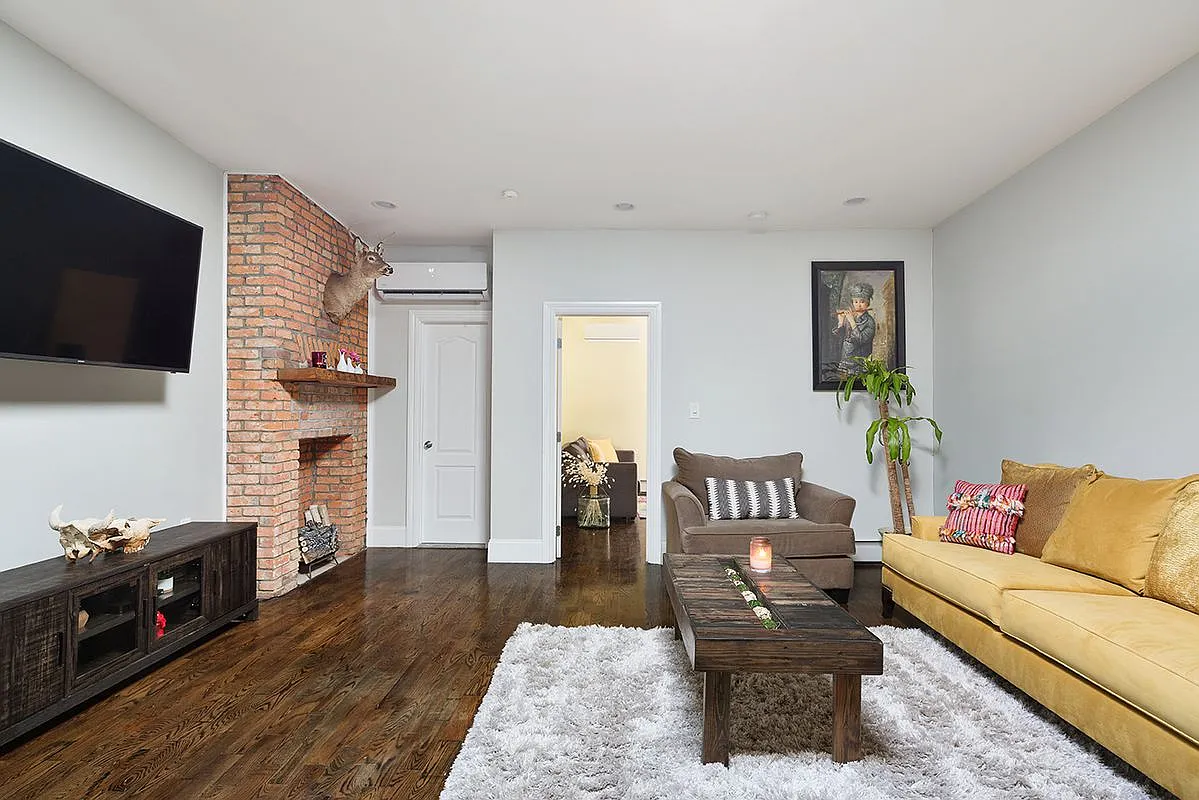 96 Sackman Street Brooklyn, NY 11233 - Photo 3 of 10 a living room with furniture and a flat screen tv