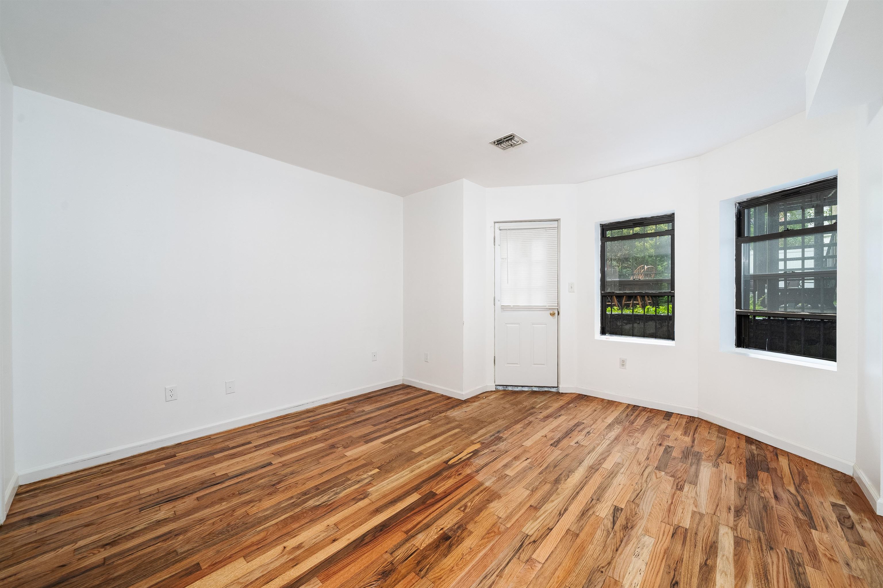 639 Garden Street, Unit 1 Hoboken, NJ 07030 - Photo 8 of 17 a view of empty room with wooden floor and fan