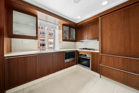a kitchen with granite countertop stainless steel appliances and wooden cabinets
