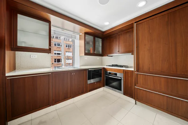 a kitchen with granite countertop stainless steel appliances and wooden cabinets