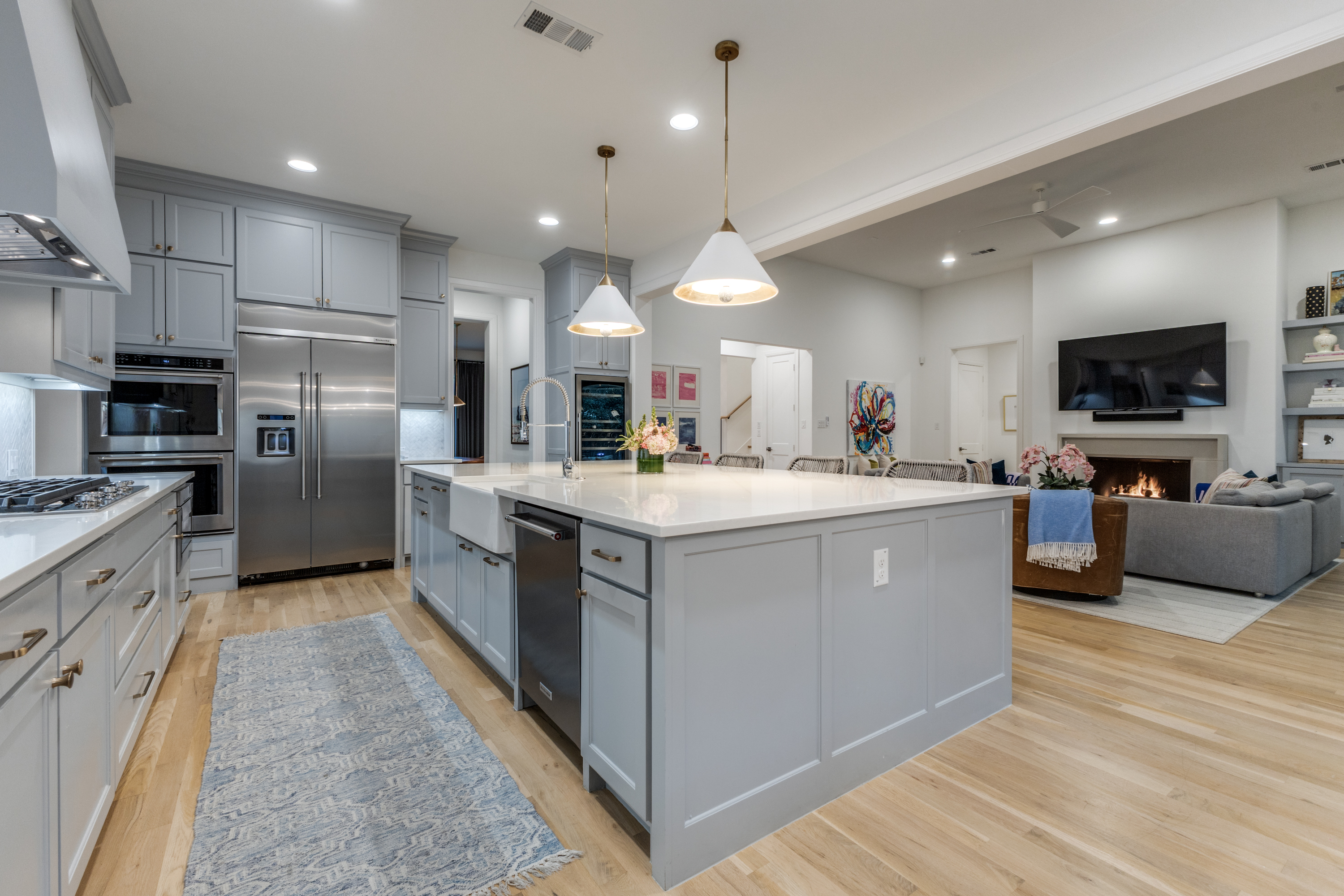 4042 Dunhaven Road Dallas, TX 75220 - Photo 15 of 34 a kitchen with stainless steel appliances kitchen island a large counter top a sink a stove and a refrigerator