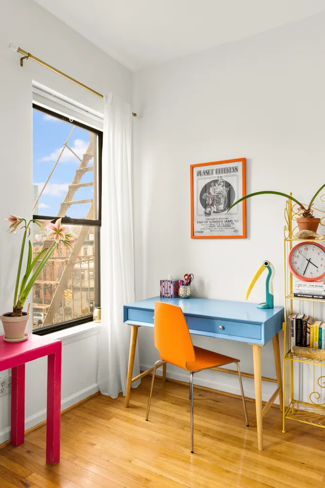 a workspace with wooden floor and a window