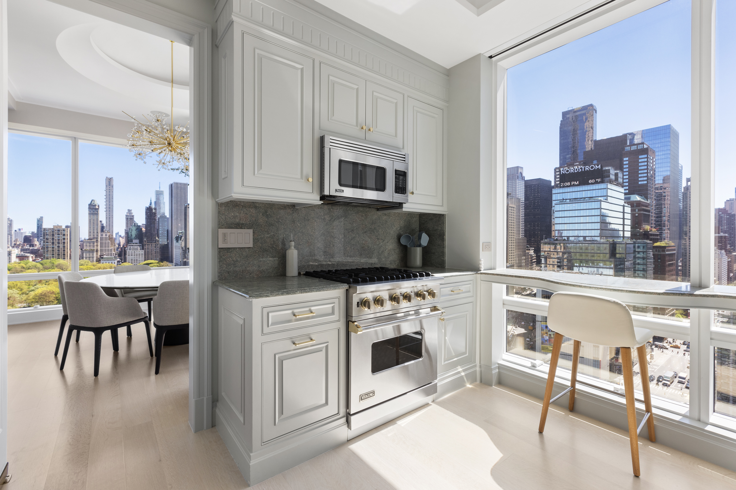 1 Central Park West, Unit 24D Manhattan, NY 10023 - Photo 6 of 19 a kitchen with a white cabinets and chairs