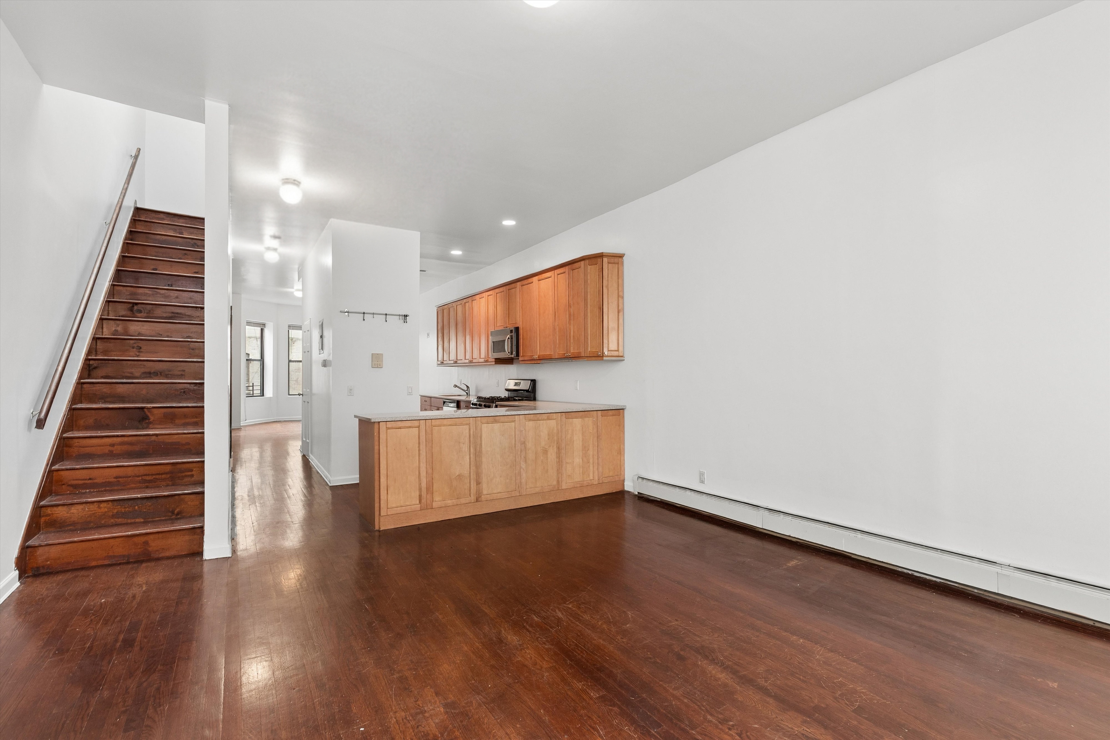 165 West 126th Street Manhattan, NY 10027 - Photo 27 of 40 a view of kitchen with cabinets and wooden floor