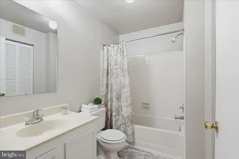 a view of a house with snow on the side of the road