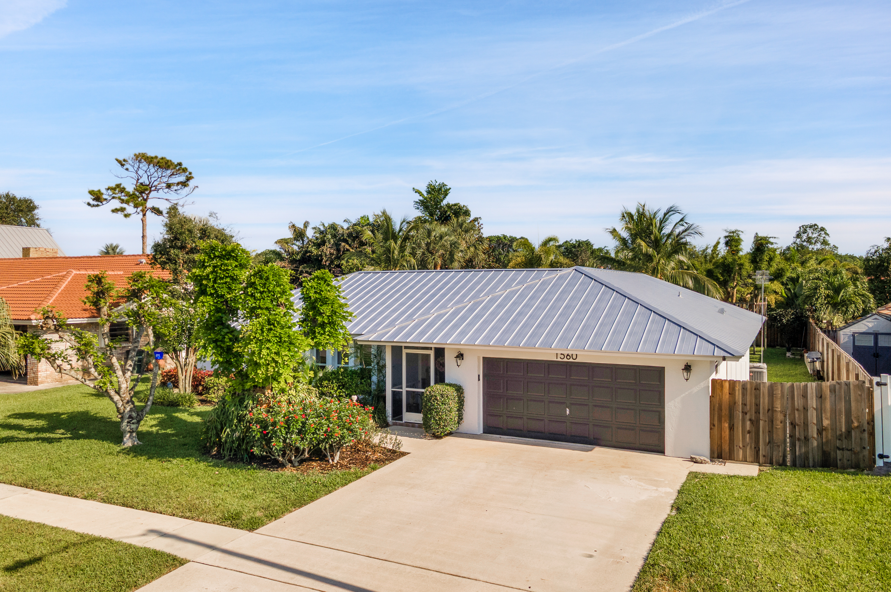 1560 Southwest 16th Street Boca Raton, FL 33486 - Photo 7 of 72 a front view of a house with a yard and garage