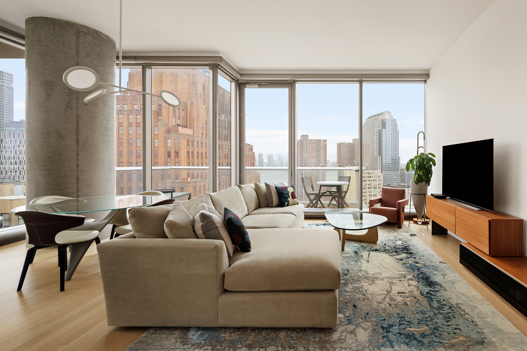 56 Leonard Street, Unit 21AWEST Manhattan, NY 10013 - Photo 2 of 11 a living room with furniture and a flat screen tv