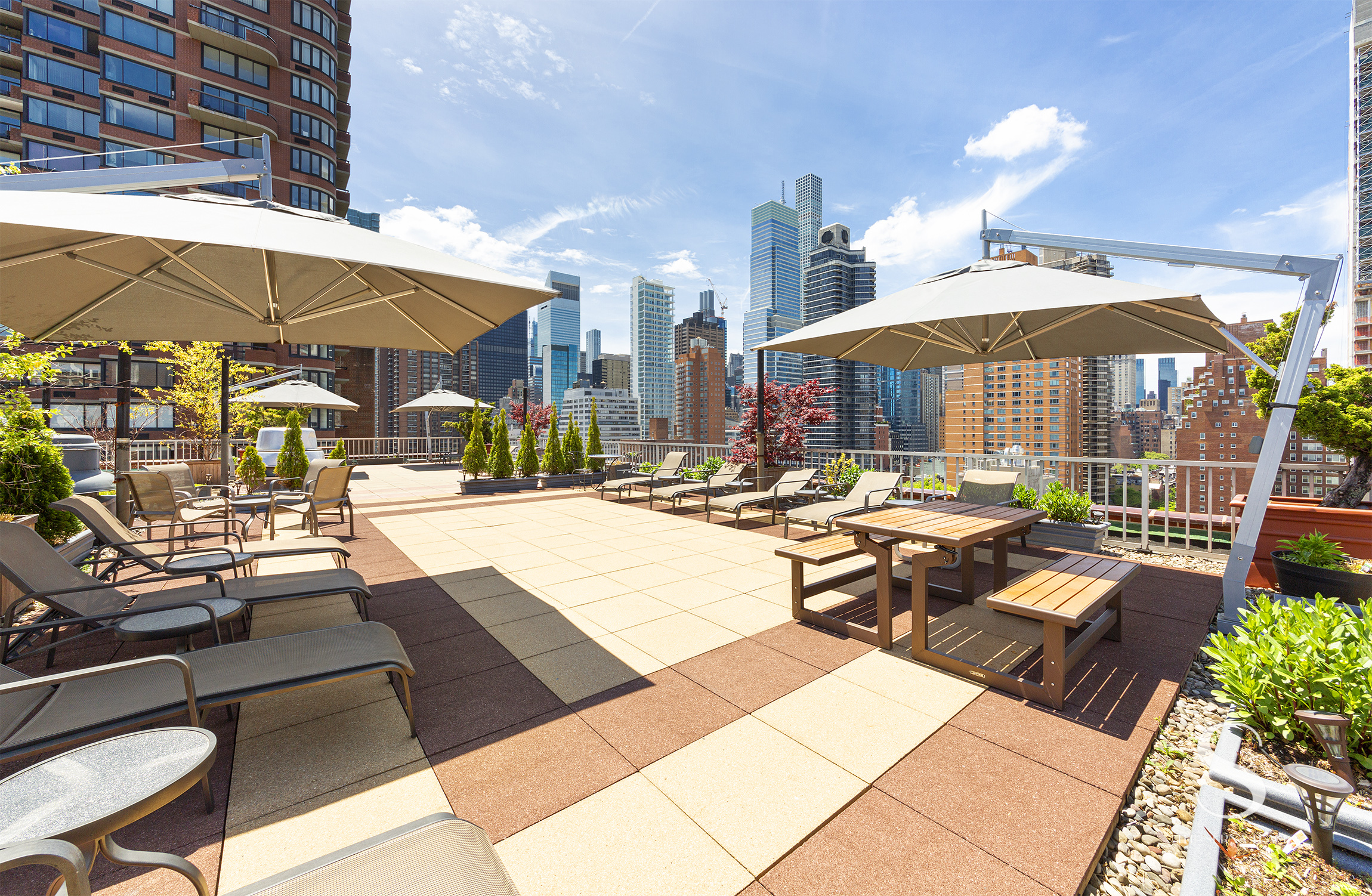 301 East 62nd Street, Unit 5E Manhattan, NY 10065 - Photo 12 of 15 a view of a patio with table and chairs under an umbrella
