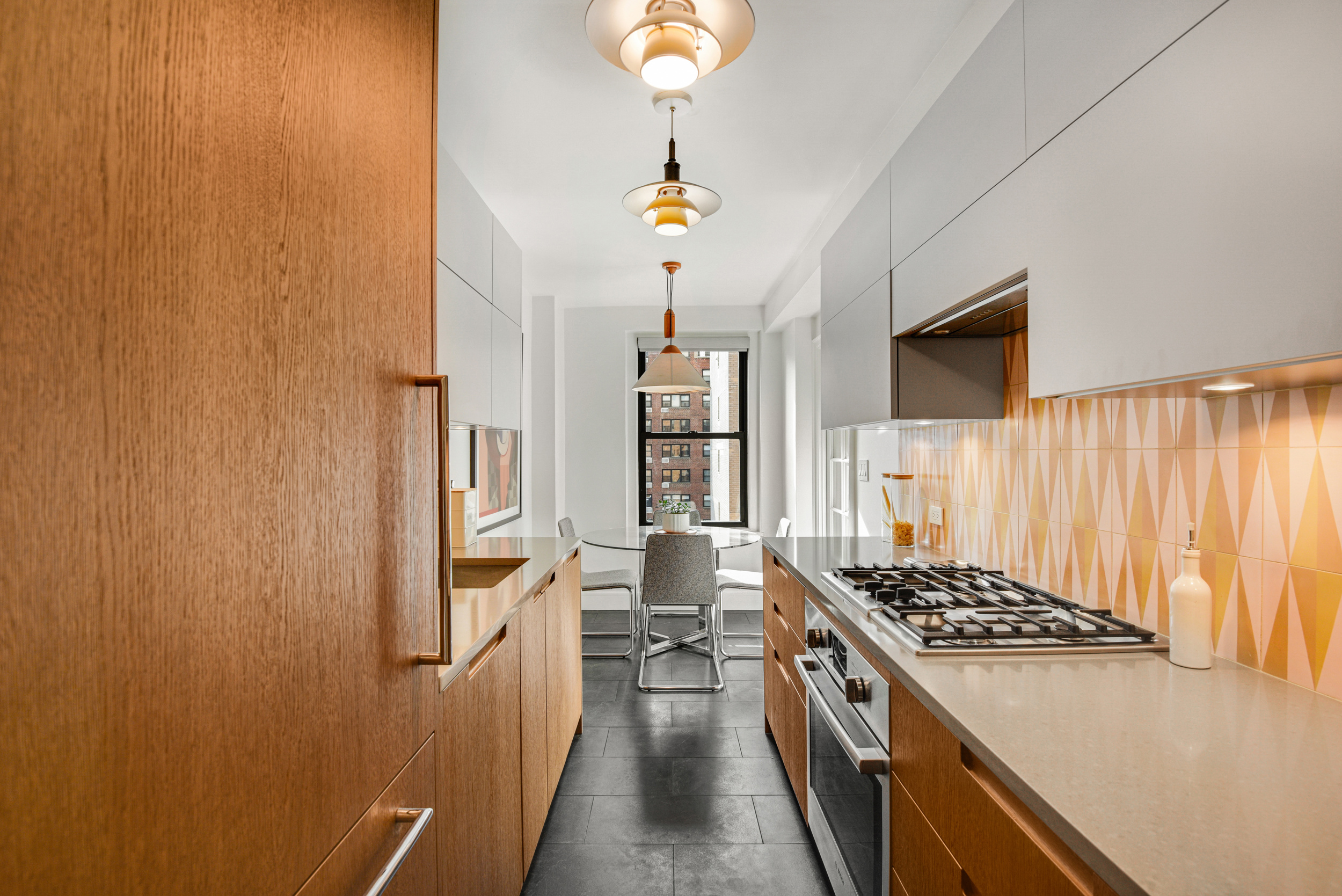 205 East 78th Street, Unit 7K Manhattan, NY 10075 - Photo 6 of 14 a kitchen with stainless steel appliances granite countertop a stove and a refrigerator