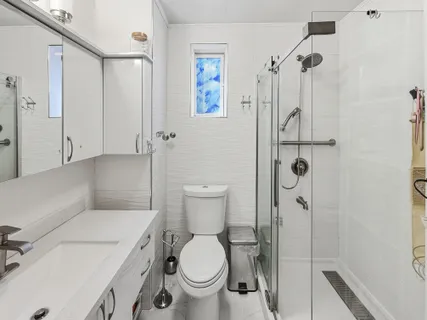 a bathroom with a toilet and a shower
