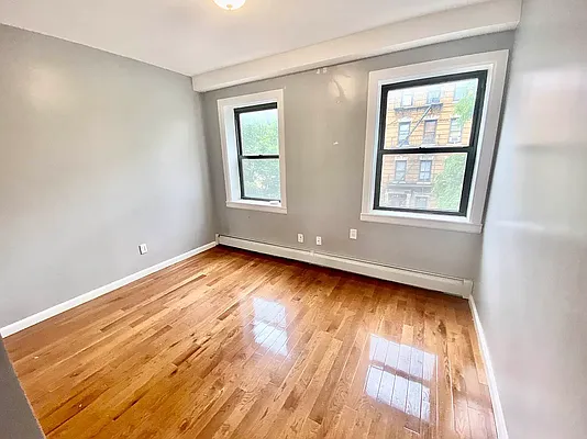 149 17th Street, Unit 3 Brooklyn, NY 11215 - Photo 5 of 7 an empty room with wooden floor and windows
