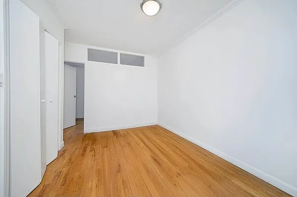 103 West 105th Street, Unit 2B Manhattan, NY 10025 - Photo 4 of 9 a view of empty room with wooden floor and fan