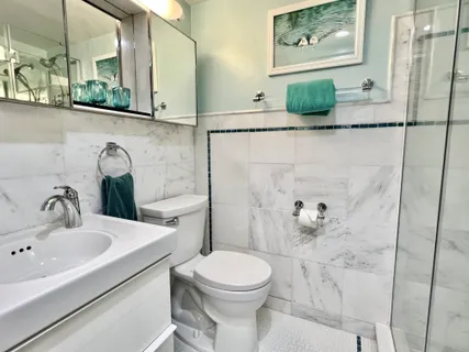 a bathroom with a glass shower door