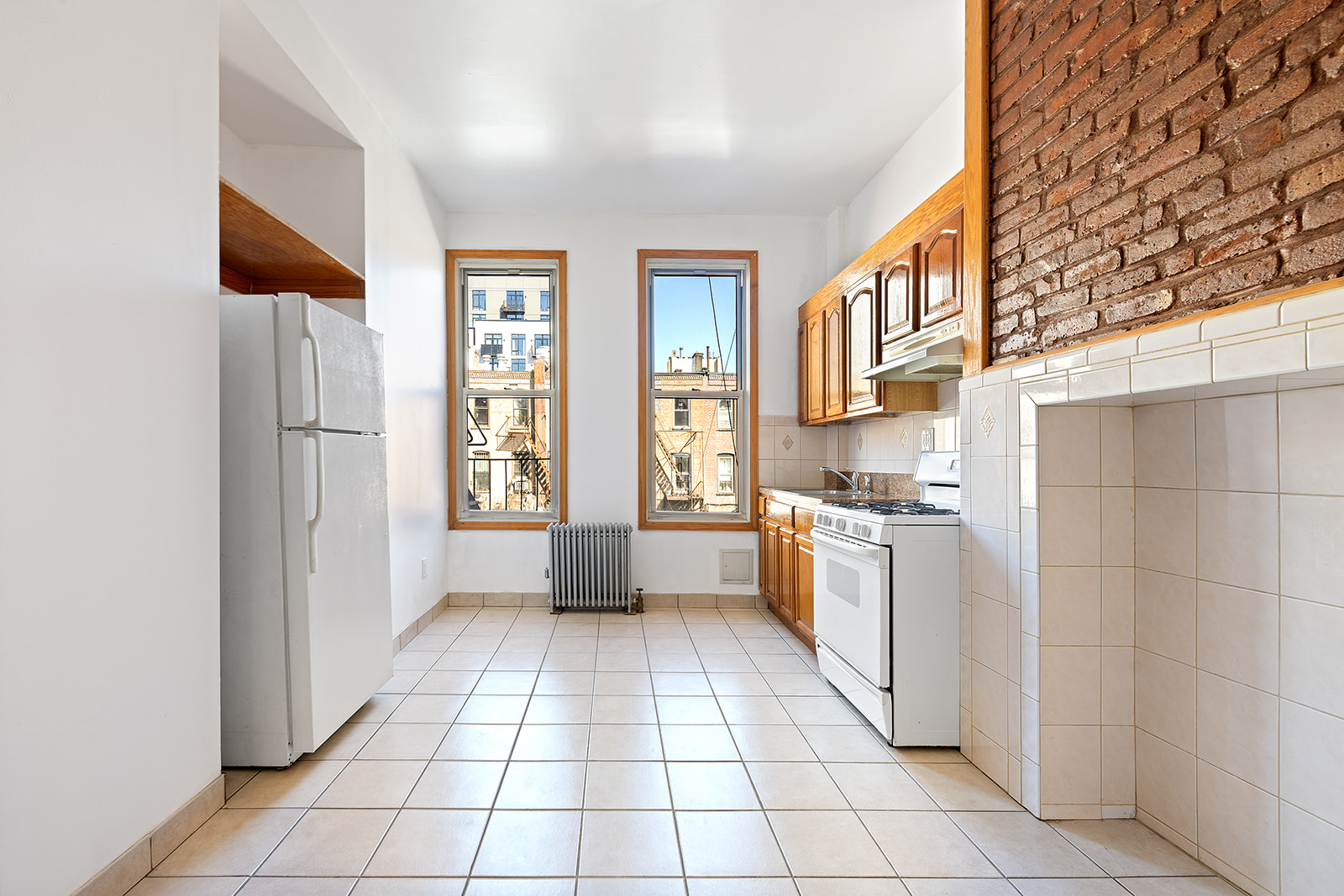 83 Maujer Street, Unit 2R Brooklyn, NY 11206 - Photo 4 of 6 a kitchen with stainless steel appliances a refrigerator and a stove top oven