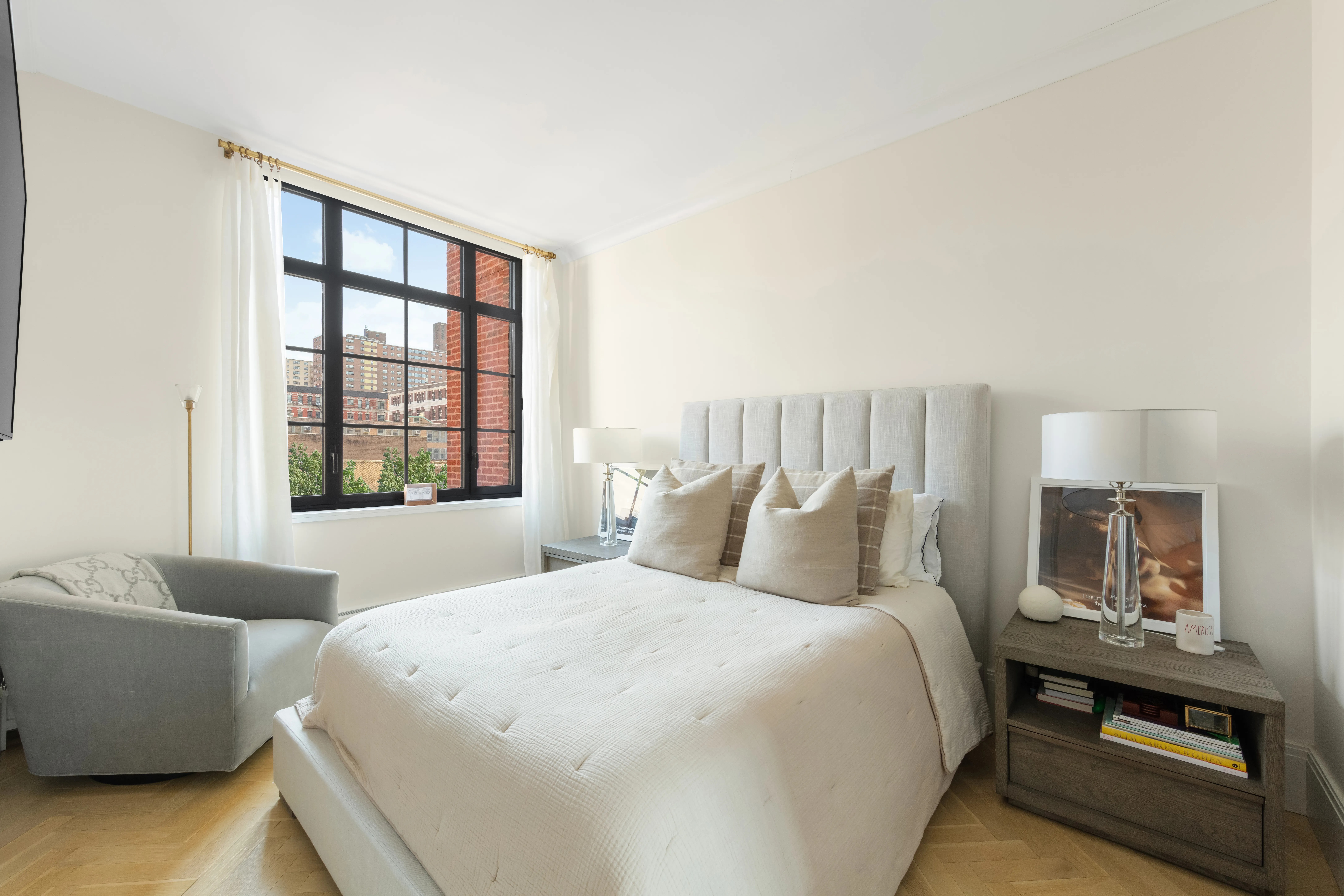 50 Clinton Street, Unit 2B Manhattan, NY 10002 - Photo 5 of 11 a bedroom with a bed and a couch with window