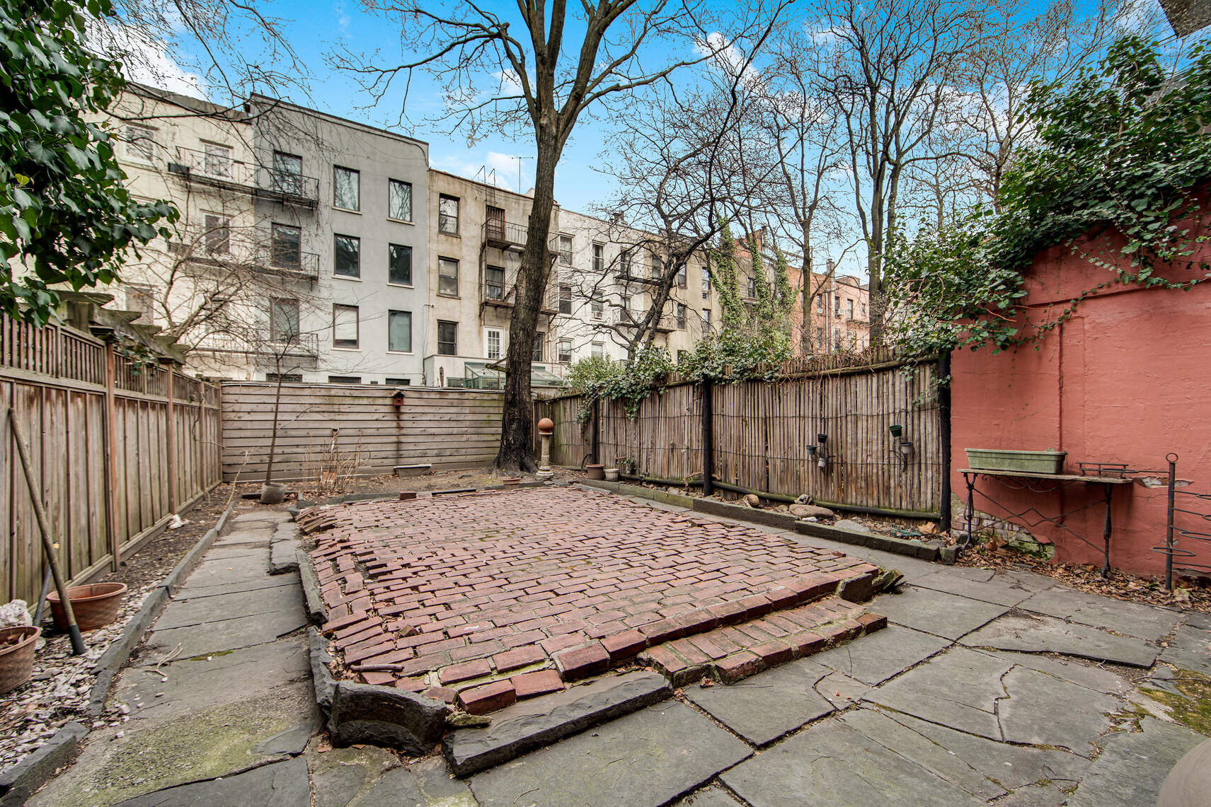 337 East 18th Street Manhattan, NY 10003 - Photo 8 of 16 a view of a backyard with wooden fence