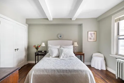 a bedroom with double bed and a window