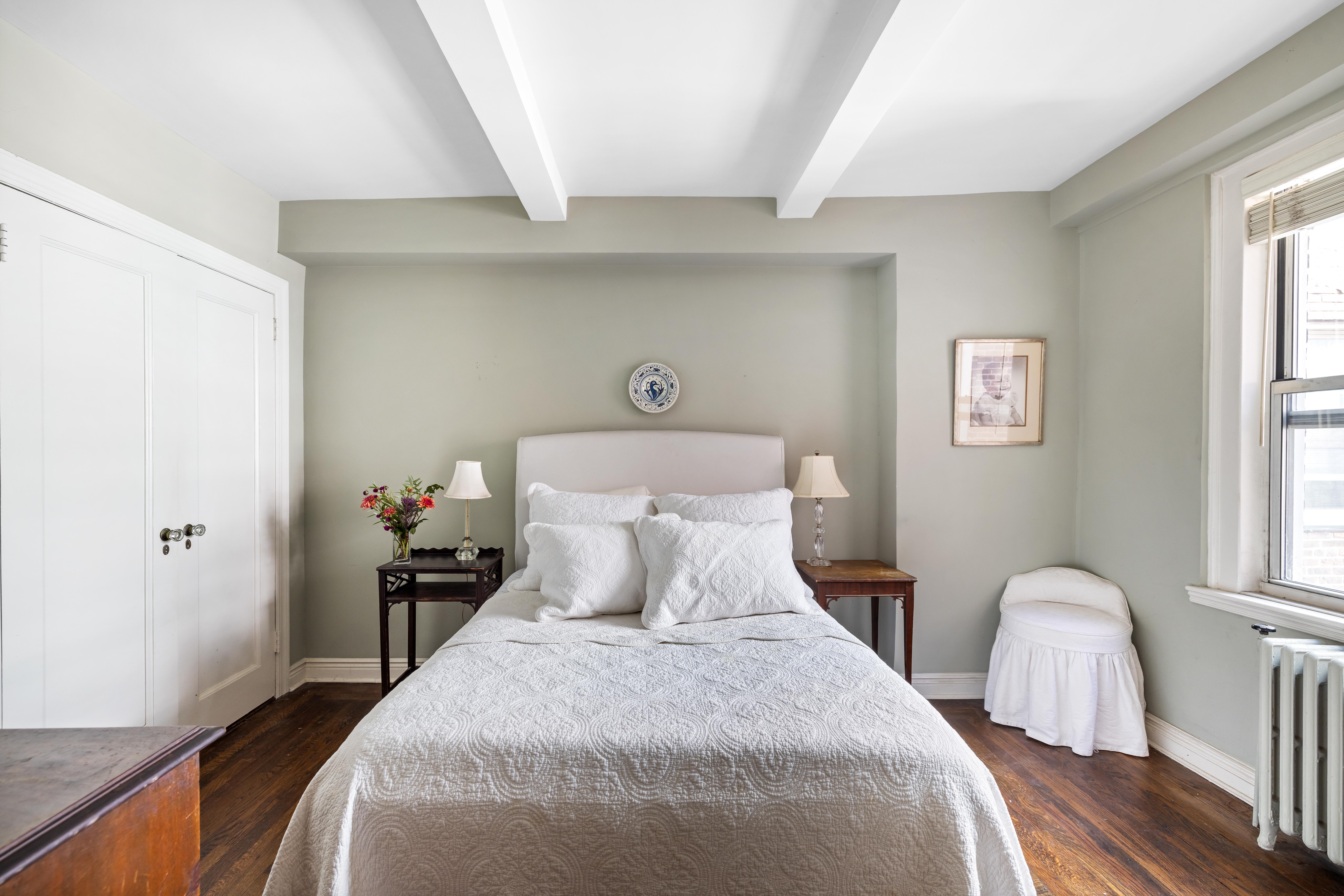 333 East 43rd Street, Unit 922 Manhattan, NY 10017 - Photo 7 of 14 a bedroom with double bed and a window