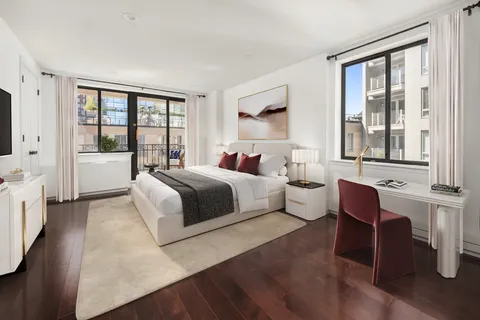 a bedroom with a large bed and a large window