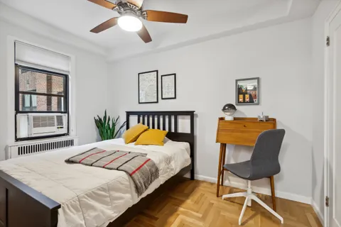 a bedroom with a bed and a chair