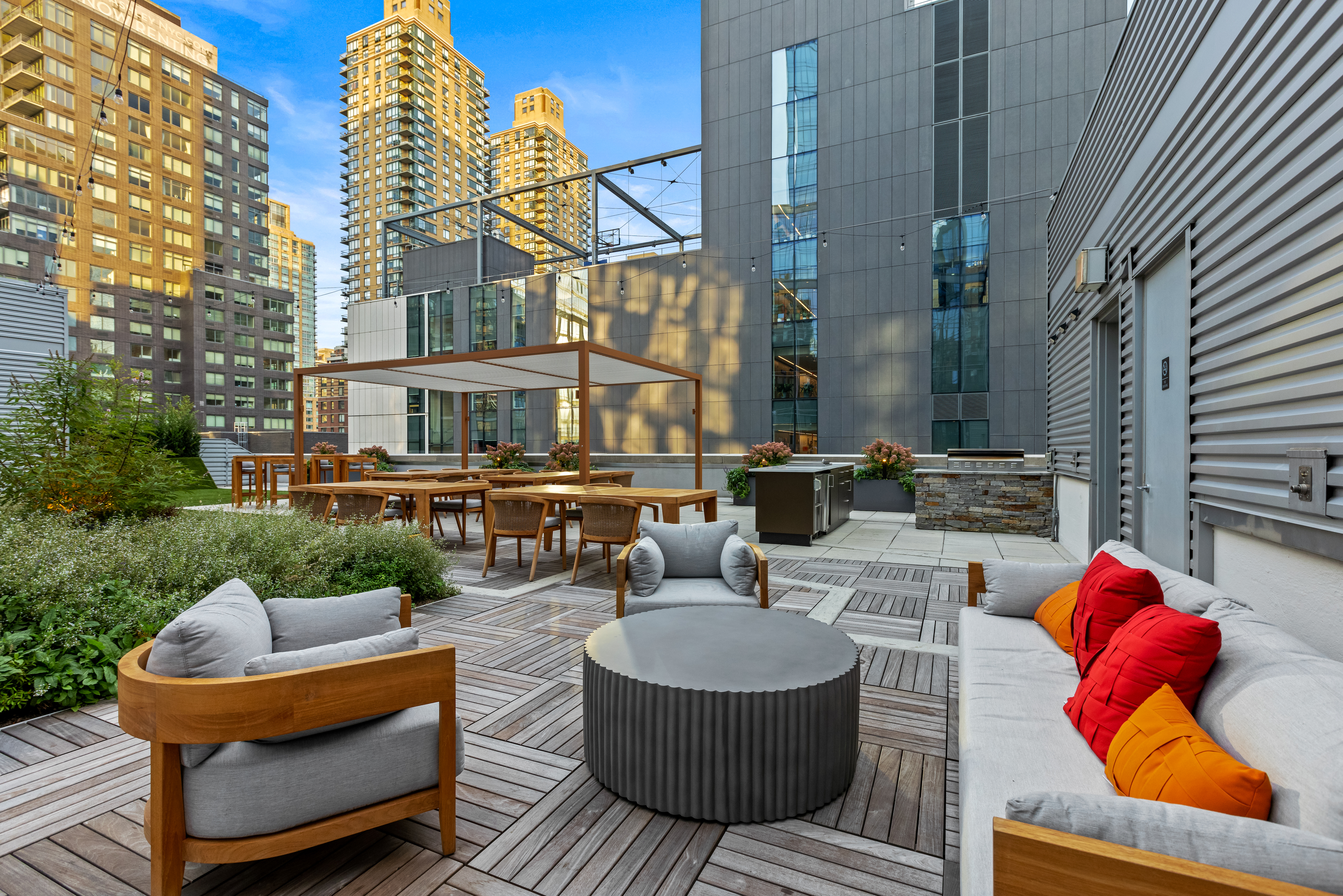 50 Riverside Boulevard, Unit 19F Manhattan, NY 10069 - Photo 18 of 24 a view of a patio with couches table and chairs and potted plants