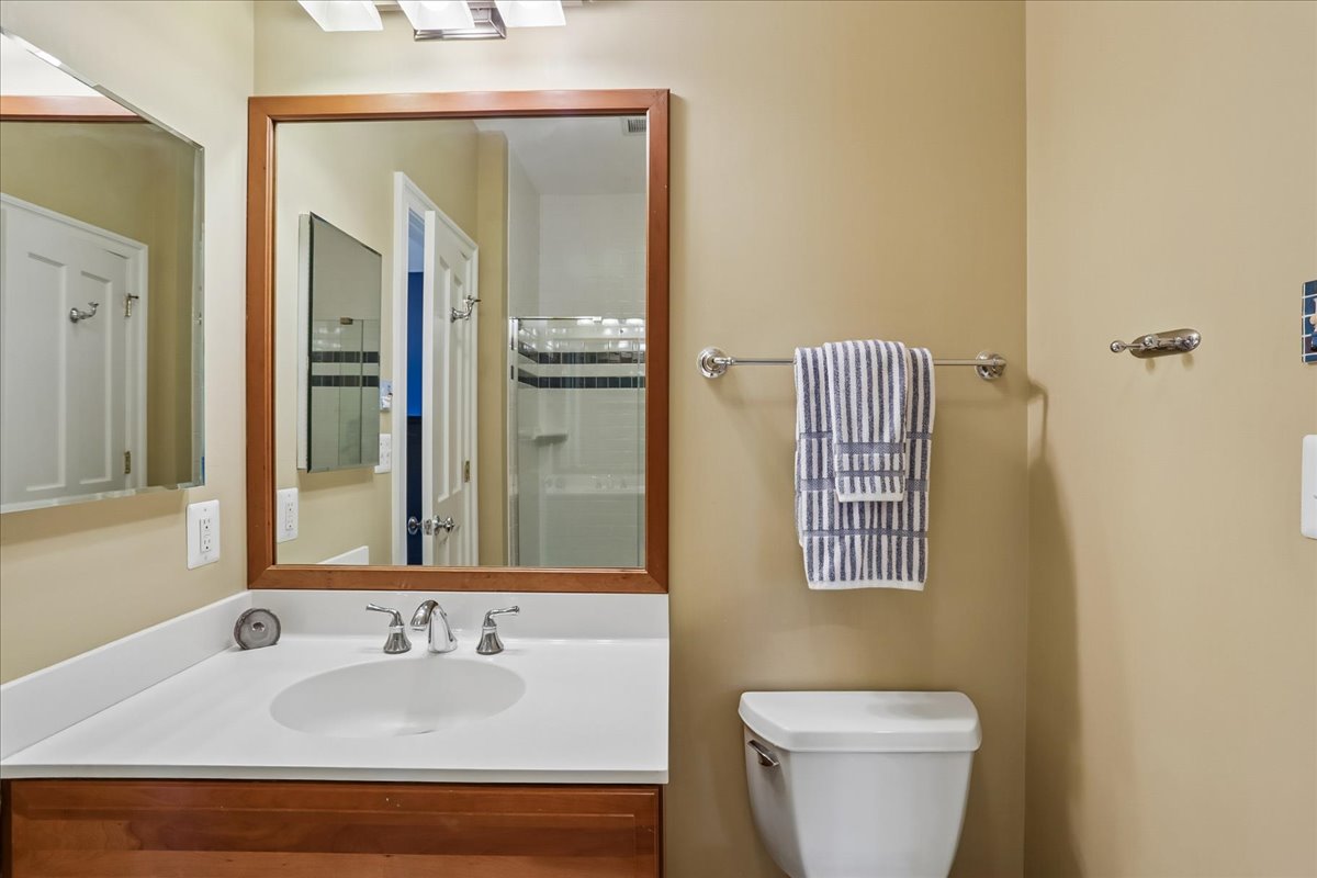 11736 Gainsborough Road Potomac, MD 20854 - Photo 77 of 90 a bathroom with a sink and mirror with toilet