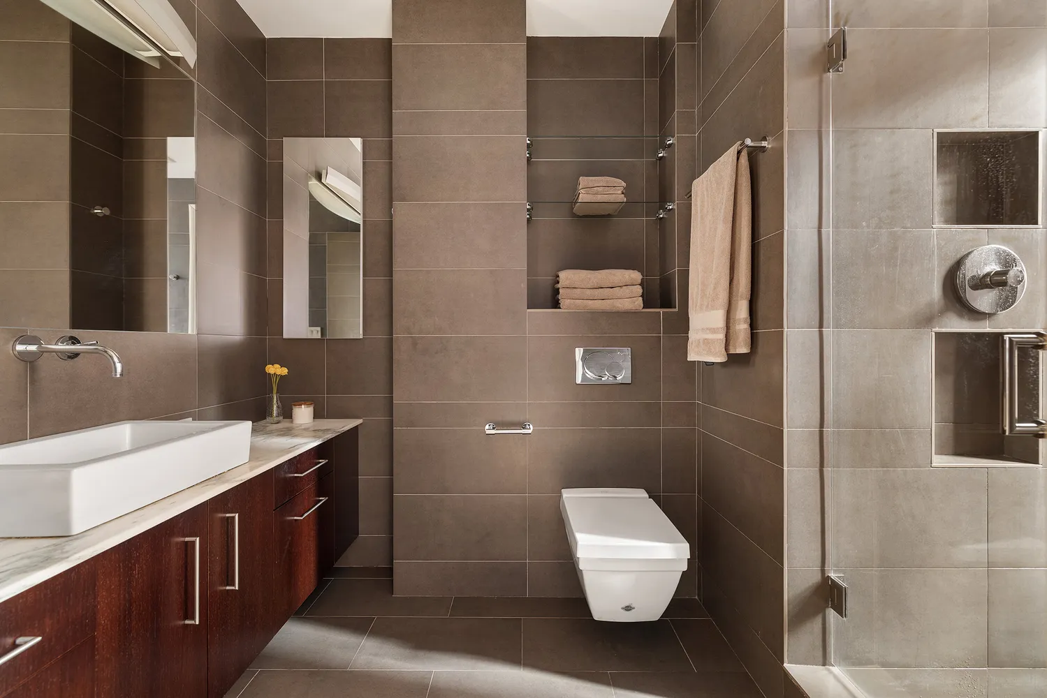 a bathroom with a double vanity sink a toilet and mirror