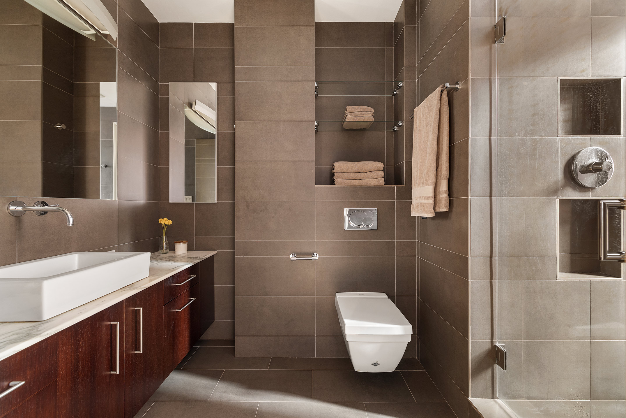 829 Park Avenue, Unit 2D/3D Manhattan, NY 10021 - Photo 10 of 21 a bathroom with a double vanity sink a toilet and mirror