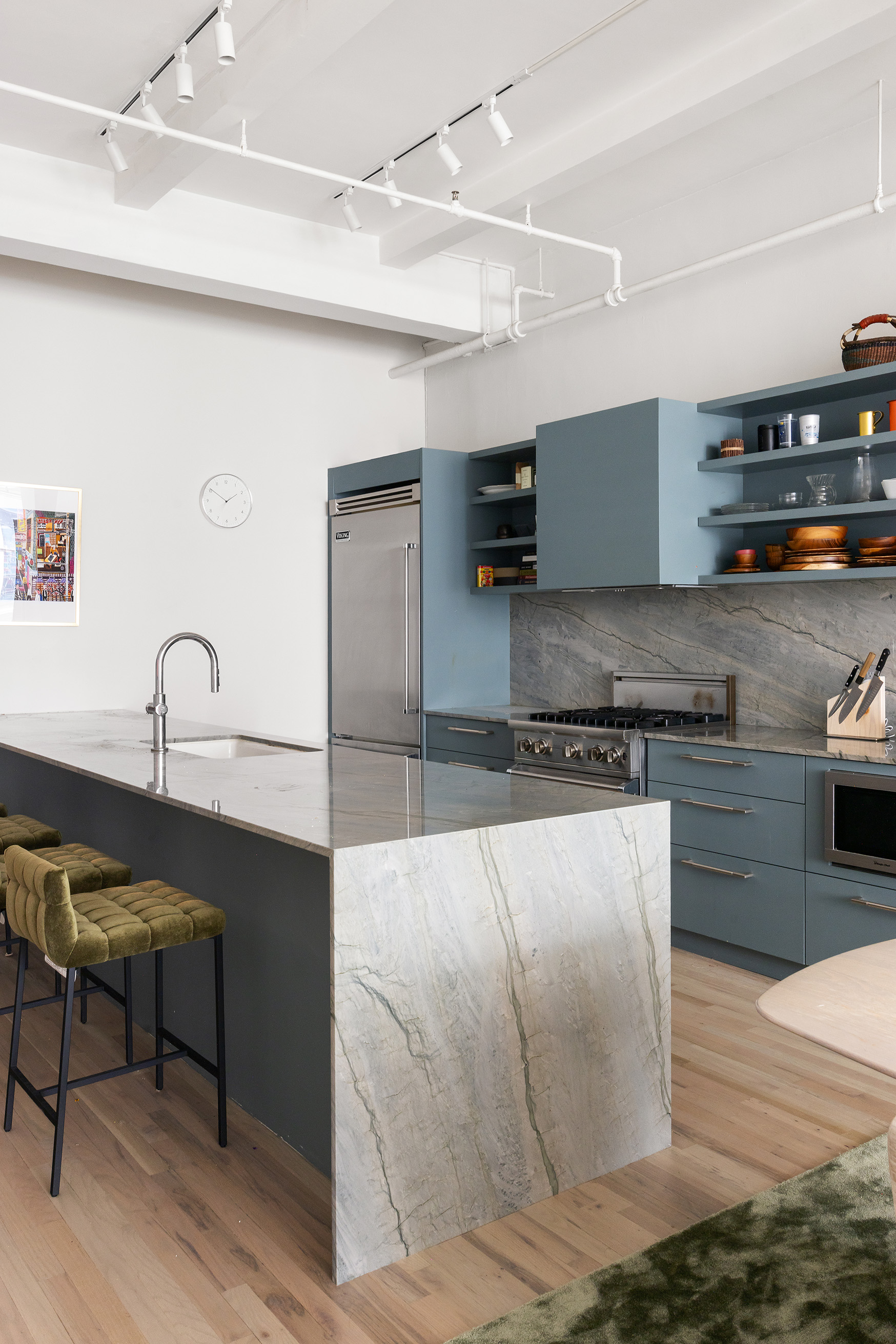 28 West 38th Street, Unit 6E Manhattan, NY 10018 - Photo 6 of 15 a kitchen with kitchen island a counter top space a sink stainless steel appliances and cabinets