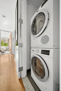 a view of a hallway with washer and dryer