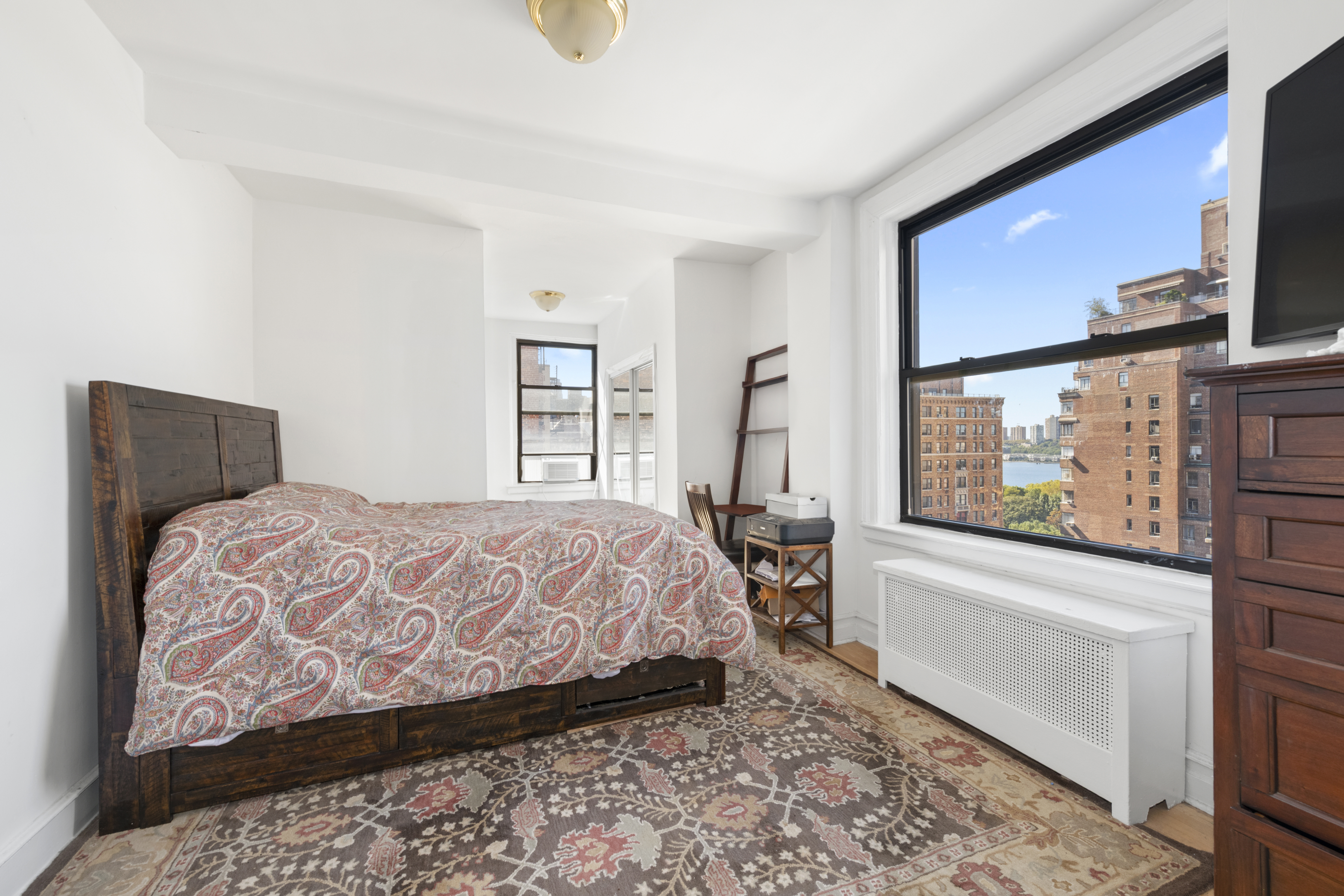 473 West End Avenue, Unit 13D Manhattan, NY 10024 - Photo 11 of 13 a bedroom with a large bed couch and a window
