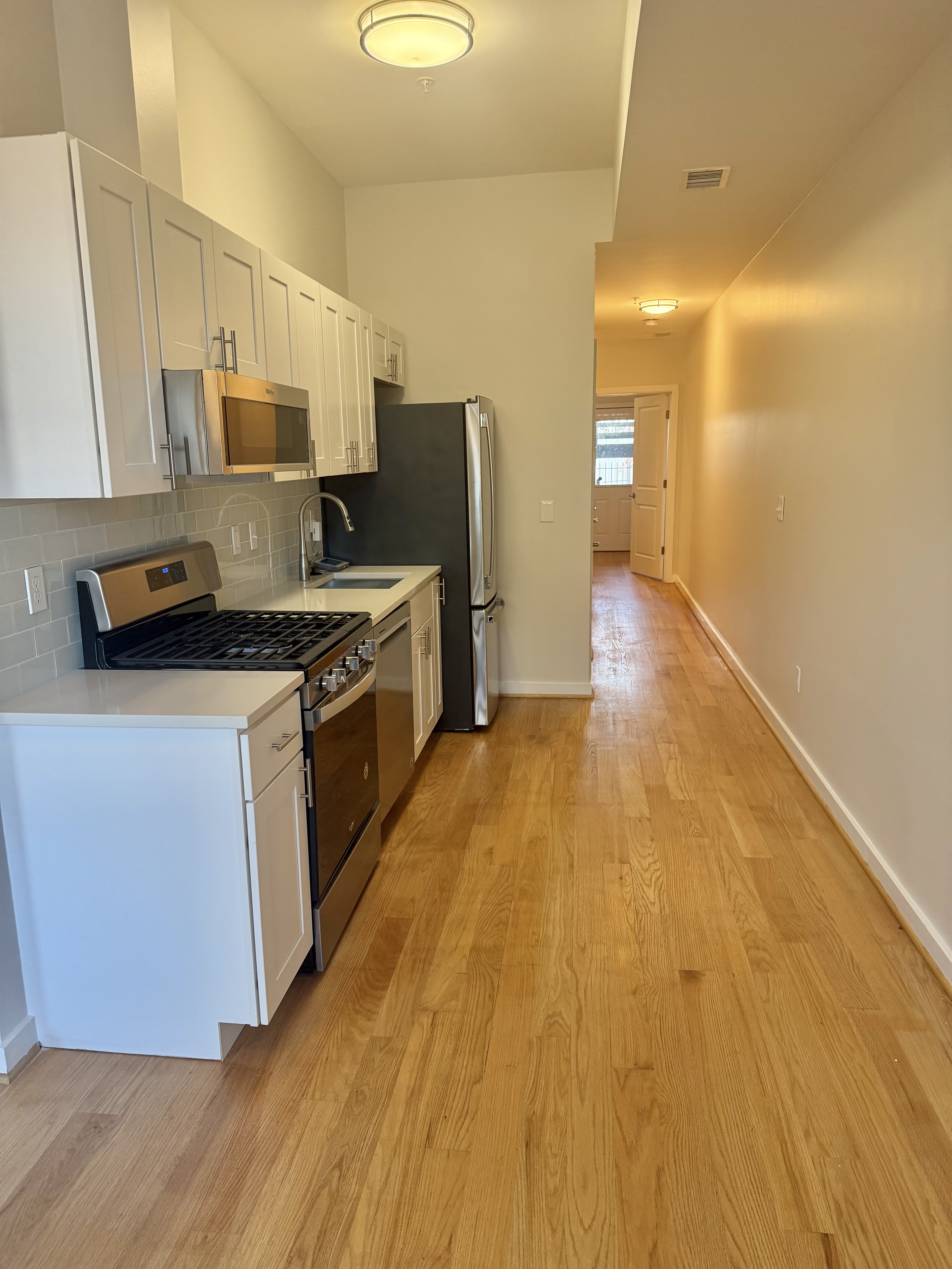 2009 Benning Road Northeast, Unit 2 Washington, DC 20002 - Photo 1 of 11 a kitchen with stainless steel appliances a stove refrigerator sink and microwave