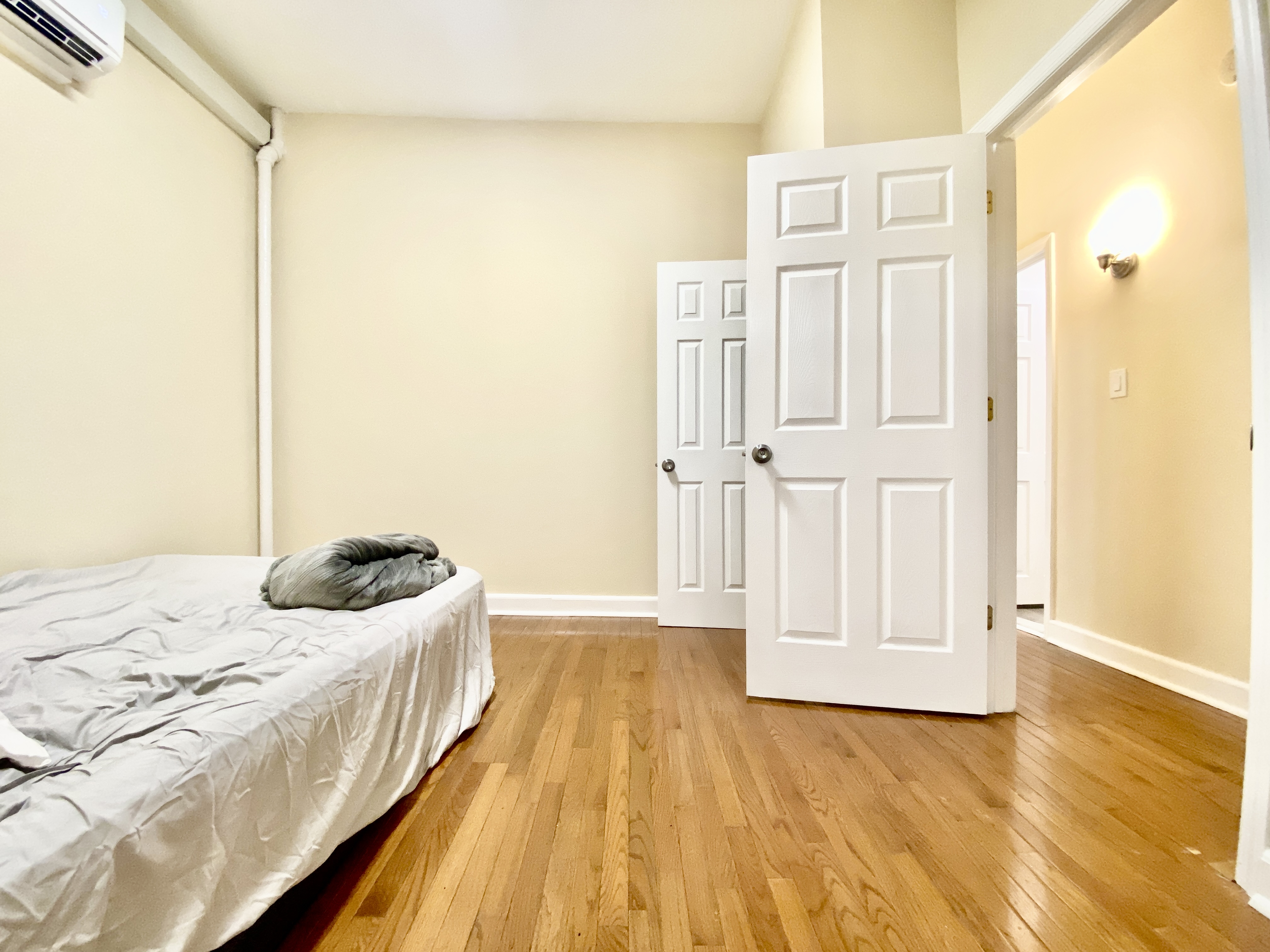 1308 Park Place, Unit 1 Brooklyn, NY 11213 - Photo 7 of 9 a bedroom with a bed and wooden floor