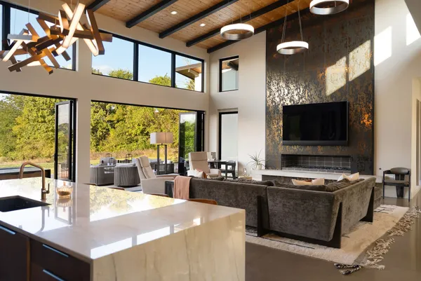 a large white kitchen with a large stove a sink dishwasher and a refrigerator with wooden floor