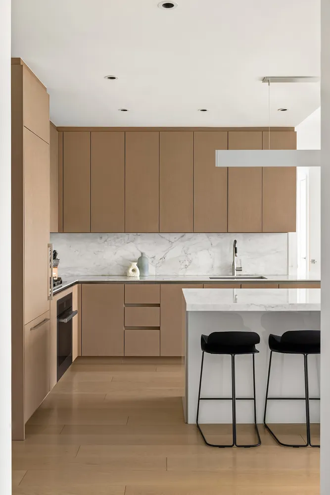 a kitchen with granite countertop a sink cabinets and stainless steel appliances