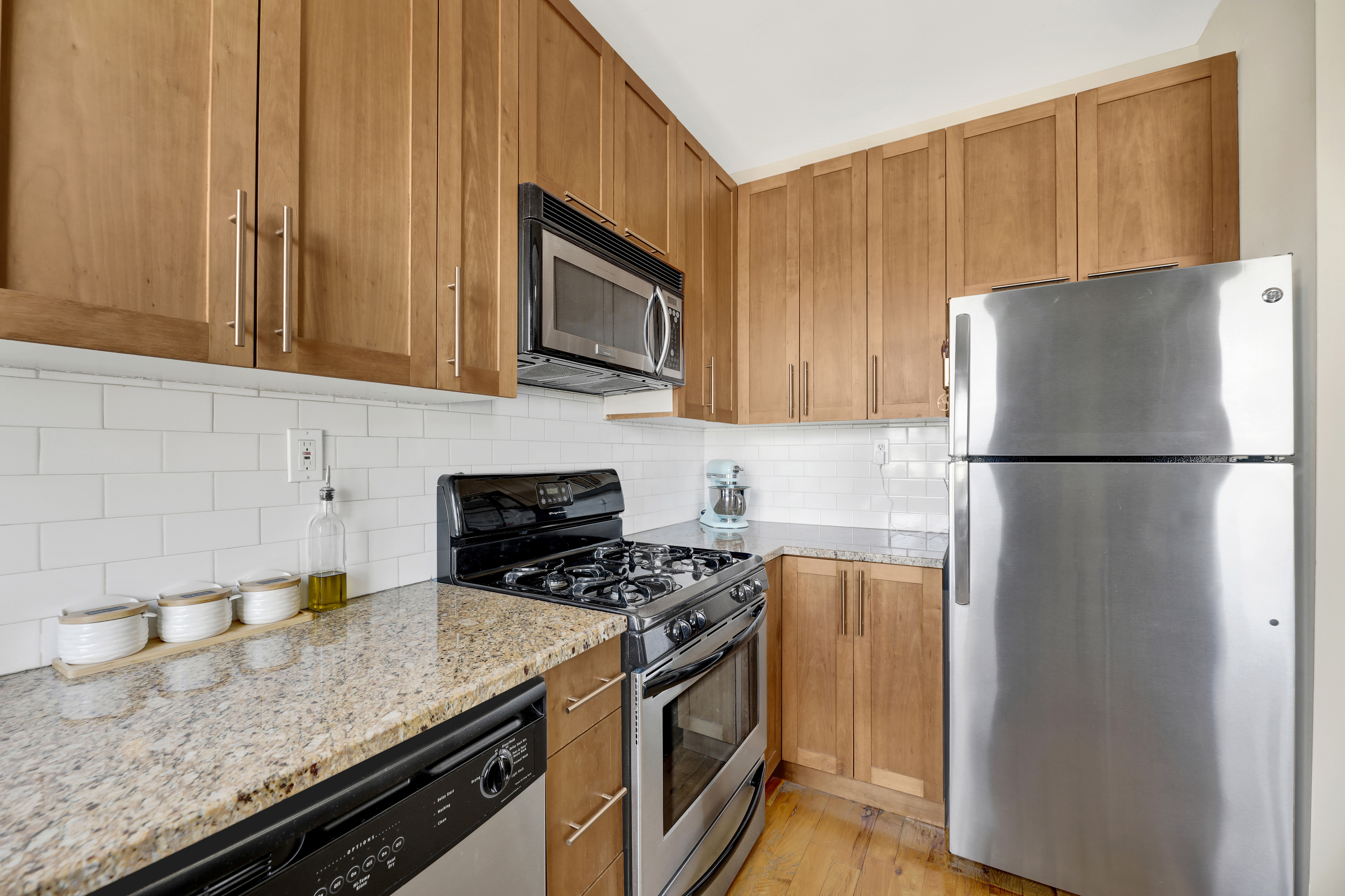36 Russell Street, Unit 22 Brooklyn, NY 11222 - Photo 12 of 27 a kitchen with stainless steel appliances granite countertop a refrigerator stove a sink and dishwasher