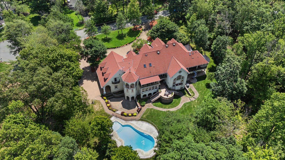 115 Skyline Drive Watchung, NJ 07069 - Photo 2 of 95 an aerial view of a house with swimming pool lawn chairs and large trees